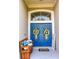 Inviting double front doors, adorned with wreaths, alongside a bench and welcome sign at 33818 Venice Ln, Sorrento, FL 32776