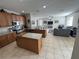 Spacious open-concept kitchen with stainless steel appliances and an island at 33818 Venice Ln, Sorrento, FL 32776