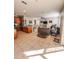 Open-concept living area with tile floors, a ceiling fan, and seamlessly connected kitchen and dining spaces at 33818 Venice Ln, Sorrento, FL 32776