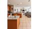 Open-concept kitchen and living room with modern finishes and comfortable seating at 33818 Venice Ln, Sorrento, FL 32776