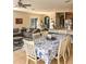 Open-concept area with a dining table, sofa, and kitchen at 33818 Venice Ln, Sorrento, FL 32776