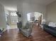 Open-concept living room with wood floors, comfortable seating, and a view of the front entrance at 33818 Venice Ln, Sorrento, FL 32776