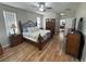 Main bedroom featuring wood floors and access to the main bathroom and walk-in closet at 33818 Venice Ln, Sorrento, FL 32776