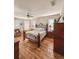 Spacious main bedroom featuring wood laminate flooring, neutral walls, a decorative bed frame, and bright windows at 33818 Venice Ln, Sorrento, FL 32776
