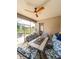 Relaxing screened-in porch featuring comfortable seating and an outdoor ceiling fan at 33818 Venice Ln, Sorrento, FL 32776