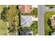 Aerial view of a home with a gray roof, manicured lawn, and proximity to the golf course at 3393 Talley Ridge Dr, The Villages, FL 32162
