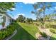 Lush backyard with landscaping and an incredible view of the golf course at 3393 Talley Ridge Dr, The Villages, FL 32162