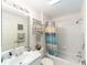 Clean bathroom featuring a tub-shower combination with a modern shower curtain and a bright vanity at 3393 Talley Ridge Dr, The Villages, FL 32162