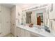 Bright bathroom with double vanity, ample lighting, and neutral finishes at 3393 Talley Ridge Dr, The Villages, FL 32162