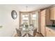 Cozy breakfast nook featuring a glass table, comfortable chairs, and natural light streaming in from nearby windows at 3393 Talley Ridge Dr, The Villages, FL 32162
