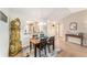 Elegant dining room featuring a wooden table set on a patterned rug and a unique grandfather clock at 3393 Talley Ridge Dr, The Villages, FL 32162