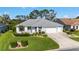An elevated view displays well-maintained landscaping, an attractive lawn, and a driveway with a three-car garage at 3393 Talley Ridge Dr, The Villages, FL 32162