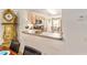 A view from the dining room into a kitchen featuring light wood cabinets and stainless steel appliances at 3393 Talley Ridge Dr, The Villages, FL 32162