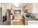 Modern kitchen featuring stainless steel appliances, ample counter space, and light wood cabinets for a clean, updated look at 3393 Talley Ridge Dr, The Villages, FL 32162