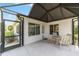Enclosed lanai with a patio set offering a relaxing outdoor space with access to the backyard at 3393 Talley Ridge Dr, The Villages, FL 32162