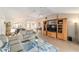 Open-concept living area featuring a neutral palette, comfortable sofas, and a stylish entertainment center for seamless living at 3393 Talley Ridge Dr, The Villages, FL 32162