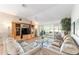Spacious living room boasting neutral tones, cozy couches, and sliding doors to a screened lanai, perfect for relaxation at 3393 Talley Ridge Dr, The Villages, FL 32162