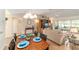 Bright, airy living room showcasing a comfortable sofa, decorative elements, and seamless flow to the adjacent dining area at 3393 Talley Ridge Dr, The Villages, FL 32162