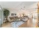 Spacious living room featuring two sofas, tile flooring, a ceiling fan, and seamless indoor-outdoor living at 3393 Talley Ridge Dr, The Villages, FL 32162