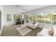 Bright sun room with plush seating, television, and outdoor view at 3393 Talley Ridge Dr, The Villages, FL 32162