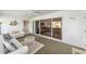 Cozy sun room with neutral decor and sliding glass doors at 3393 Talley Ridge Dr, The Villages, FL 32162