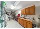 Well-organized workshop with wooden cabinets, open shelving, and a workbench area at 3393 Talley Ridge Dr, The Villages, FL 32162