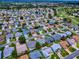 Aerial view of a community with golf course, lake and a home outlined in red at 3432 Fairfield St, The Villages, FL 32162
