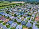 Aerial view of a neighborhood with a golf course and a home outlined in red at 3432 Fairfield St, The Villages, FL 32162