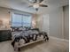 Inviting bedroom featuring a ceiling fan, two bedside tables, and natural light coming in through the window at 3432 Fairfield St, The Villages, FL 32162