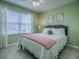Comfortable bedroom with a queen bed, light green walls, white trim, and a ceiling fan at 3432 Fairfield St, The Villages, FL 32162
