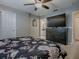 Bedroom with a view into the bathroom featuring a black dresser with a TV, and luxury vinyl plank flooring at 3432 Fairfield St, The Villages, FL 32162