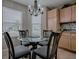Cozy dining area featuring a glass-top table, four chairs, and natural lighting from a window at 3432 Fairfield St, The Villages, FL 32162