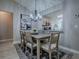 Elegant dining room with modern decor, a stylish chandelier, and a view into the kitchen at 3432 Fairfield St, The Villages, FL 32162
