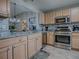 Modern kitchen with stainless steel appliances, granite countertops, and tile backsplash at 3432 Fairfield St, The Villages, FL 32162