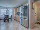 Bright kitchen-dining area with stainless steel refrigerator and a chandelier over the table at 3432 Fairfield St, The Villages, FL 32162