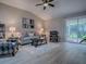 Comfortable living room with vaulted ceilings, stylish furniture, and sliding glass doors to a patio at 3432 Fairfield St, The Villages, FL 32162