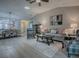 Open-concept living area with natural light, modern decor, and a seamless flow to the dining space at 3432 Fairfield St, The Villages, FL 32162