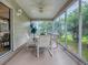 Enclosed lanai with ceiling fan and large sliding doors that lead out to the backyard at 3432 Fairfield St, The Villages, FL 32162