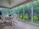 Enclosed lanai with table set with seating for four with large glass panels for maximum sunlight at 3432 Fairfield St, The Villages, FL 32162