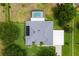 An aerial view shows the home's layout with solar panels, screen enclosed pool, and lush backyard at 36455 Clara St, Eustis, FL 32736