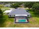 Aerial view of home featuring a screened pool, well-maintained landscaping, and proximity to green spaces at 36455 Clara St, Eustis, FL 32736