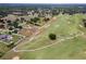 Aerial shot showcases the neighborhood's beautiful golf course, lush greenery, and serene lakes at 36455 Clara St, Eustis, FL 32736