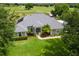 Stunning aerial view of a beautiful gray roofed home on a lush green lawn near a golf course at 36455 Clara St, Eustis, FL 32736