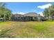 Lawn and back of house showing the screened-in pool and well maintained yard at 36455 Clara St, Eustis, FL 32736