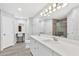 Bathroom with double vanity, quartz counters, and a large mirror at 36455 Clara St, Eustis, FL 32736
