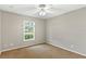 Bright bedroom featuring neutral walls, a window providing natural light, and carpeted floors at 36455 Clara St, Eustis, FL 32736
