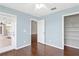 Bedroom with hardwood floors, ceiling fan, and access to outdoor patio at 36455 Clara St, Eustis, FL 32736