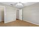 Cozy bedroom featuring neutral walls, a window providing natural light, carpeted floors, and a ceiling fan at 36455 Clara St, Eustis, FL 32736