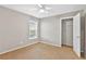 Neutral bedroom featuring tan carpet, a ceiling fan, and a closet at 36455 Clara St, Eustis, FL 32736