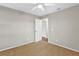 Bedroom featuring tan carpet, a ceiling fan, and an attached closet at 36455 Clara St, Eustis, FL 32736